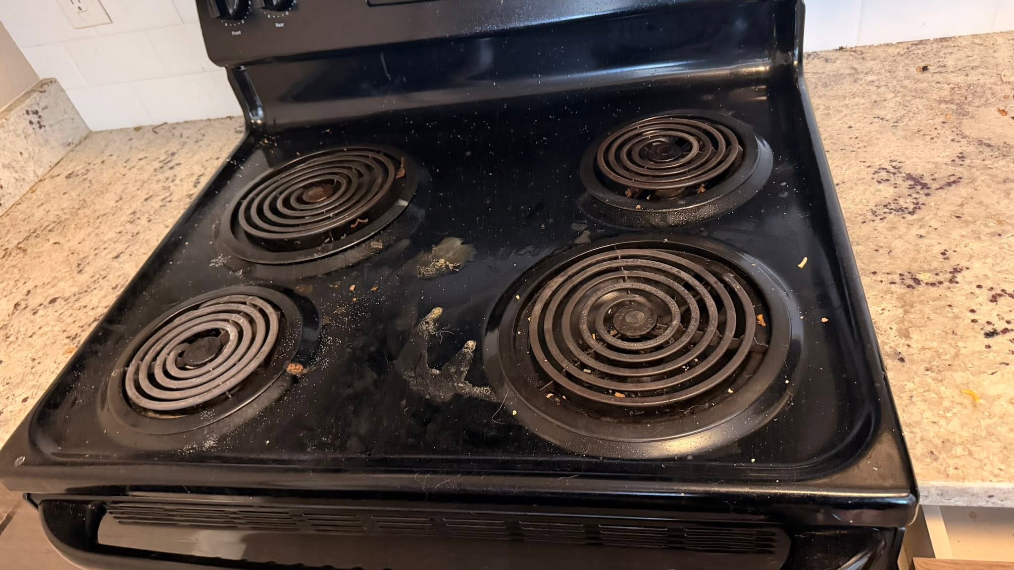 Greasy stove with food residue before cleaning